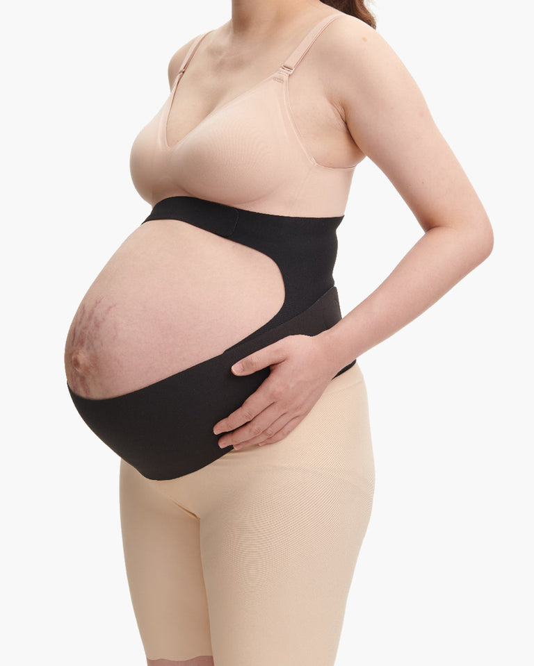 Translation missing: en.Black Momcozy BumpEase maternity band on pregnant person, showing ergonomic support fit